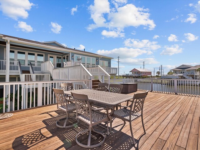 wooden terrace featuring a water view