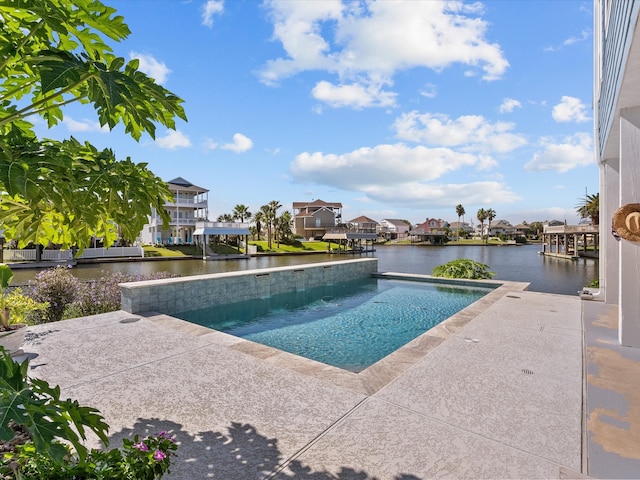 view of pool with a water view and a patio area