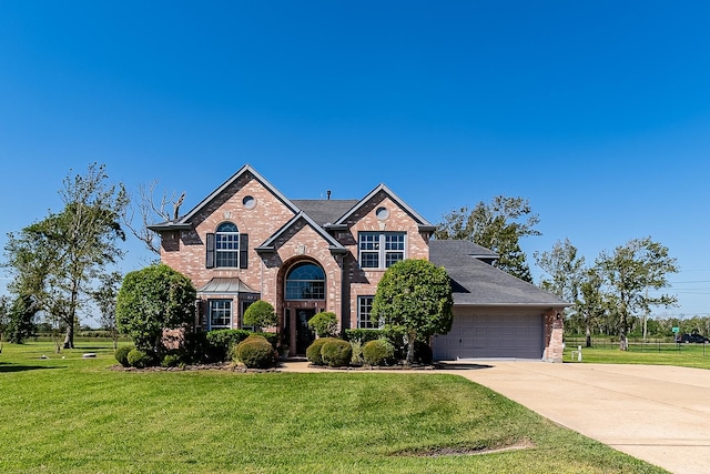 view of front of house featuring a garage and a front lawn