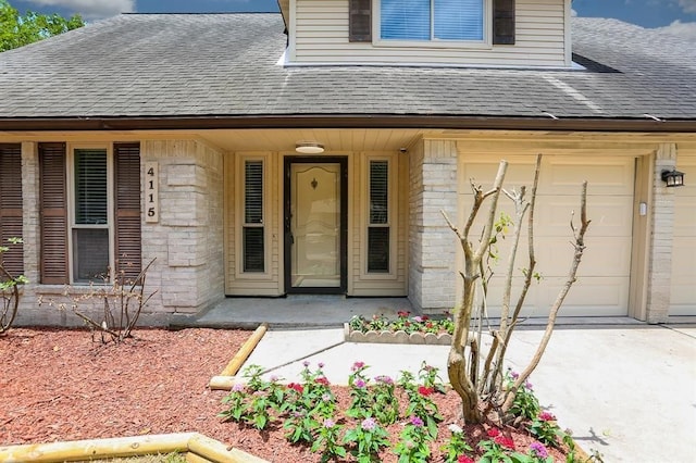 doorway to property with covered porch and a garage