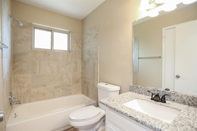 full bathroom with toilet, tiled shower / bath, and vanity