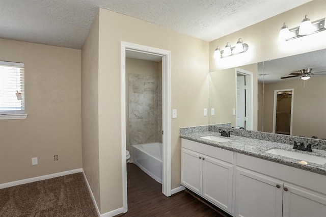 bathroom with vanity, ceiling fan, a textured ceiling, and hardwood / wood-style floors