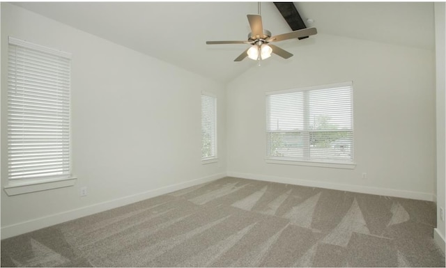 empty room featuring ceiling fan, vaulted ceiling with beams, and carpet floors