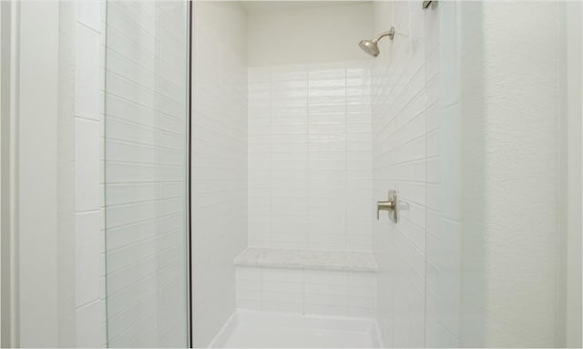 bathroom with a tile shower