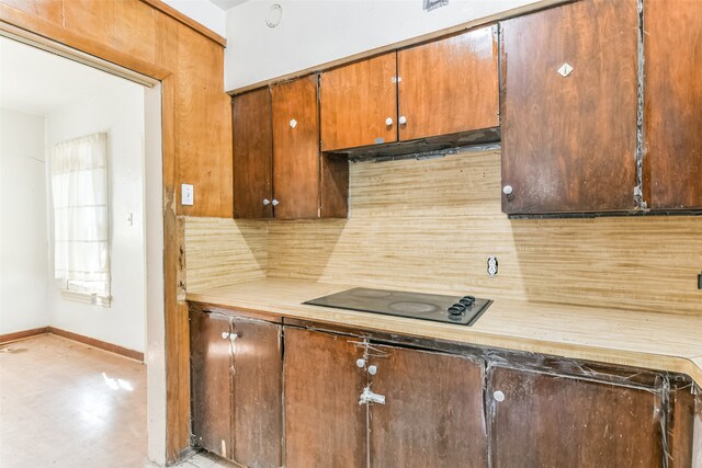 kitchen featuring black electric stovetop and tasteful backsplash