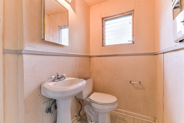 bathroom featuring tile walls, toilet, and tile patterned floors