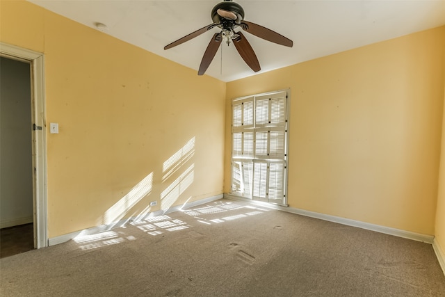 empty room featuring ceiling fan and carpet floors