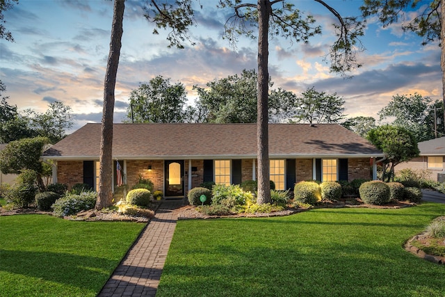 ranch-style house with a lawn