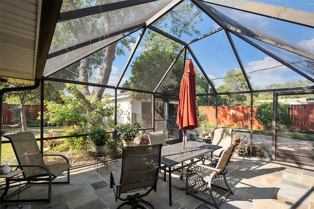 view of patio / terrace featuring glass enclosure