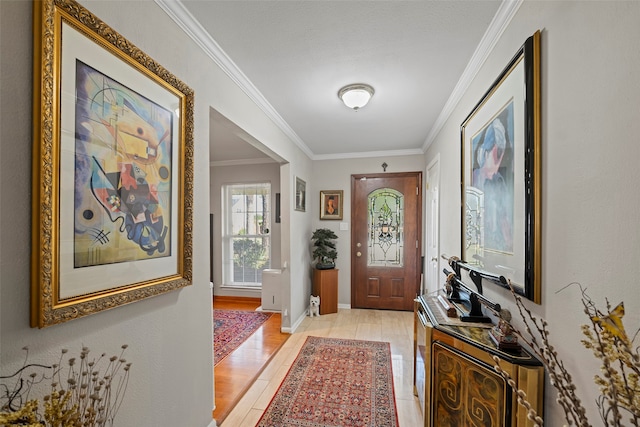 entryway with light wood-type flooring and ornamental molding