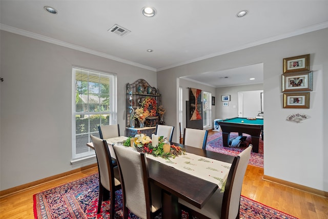 dining space with ornamental molding, billiards, and light hardwood / wood-style floors