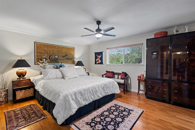 bedroom featuring crown molding, ceiling fan, and light hardwood / wood-style flooring