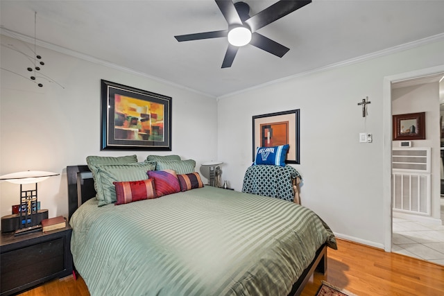 bedroom with wood-type flooring, crown molding, and ceiling fan