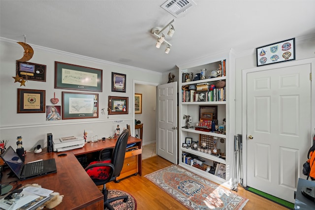 office area featuring ornamental molding, rail lighting, and light hardwood / wood-style flooring