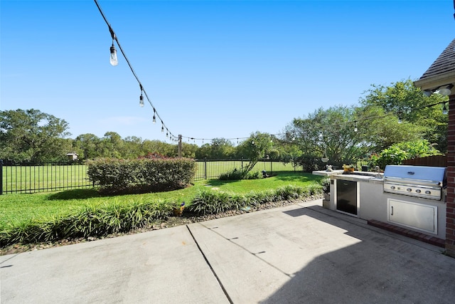 view of patio / terrace featuring grilling area and an outdoor kitchen