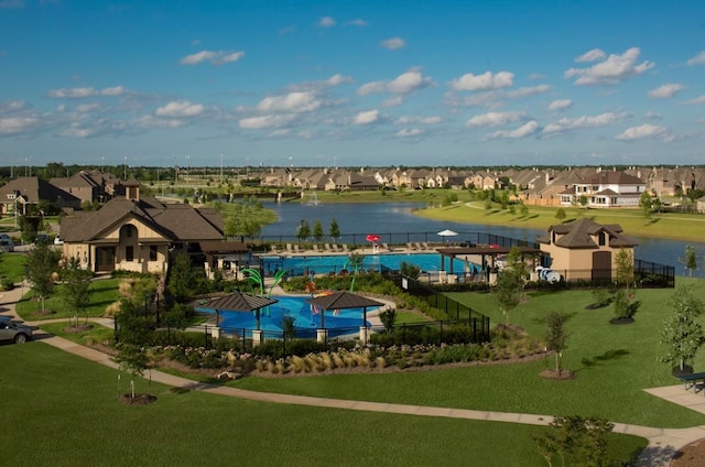 view of pool featuring a yard and a water view