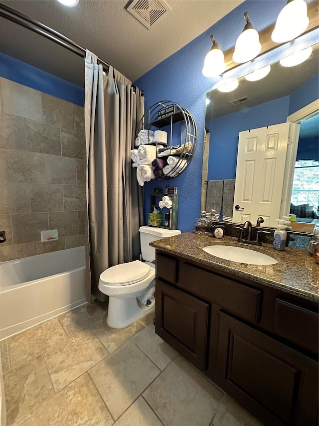 full bathroom featuring vanity, shower / bath combo, a textured ceiling, and toilet