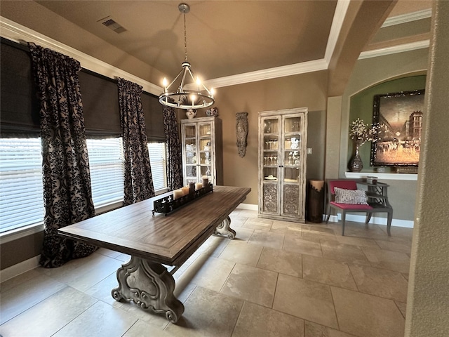 dining area featuring ornamental molding and a chandelier