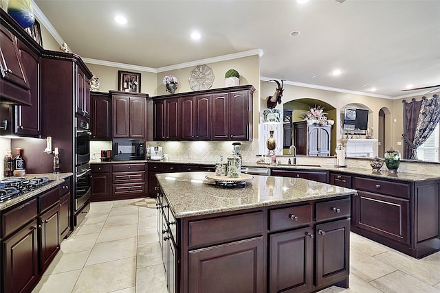 kitchen featuring sink, ornamental molding, a center island, and kitchen peninsula