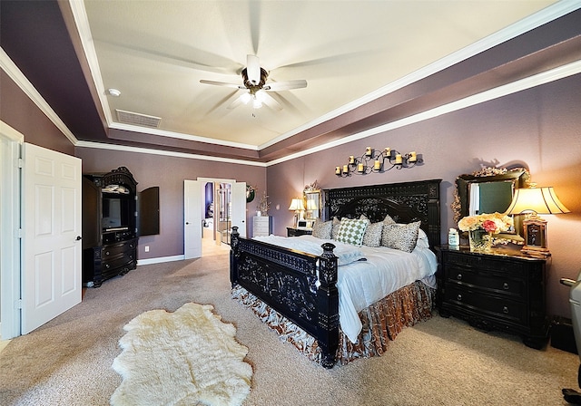 bedroom featuring ceiling fan, light carpet, a tray ceiling, and crown molding