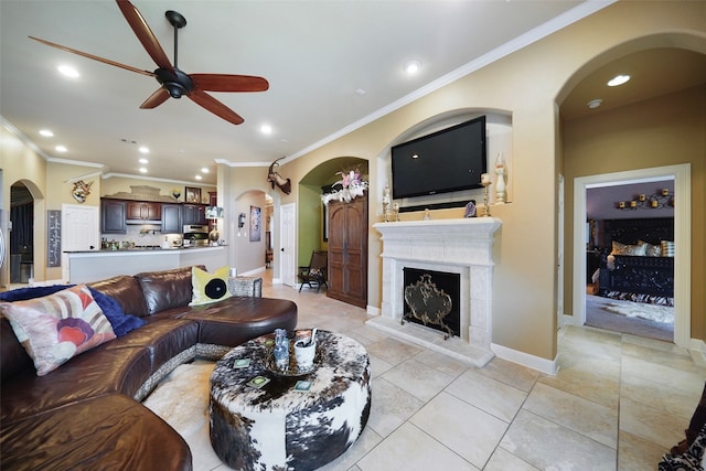 living room with crown molding, light tile patterned flooring, and ceiling fan