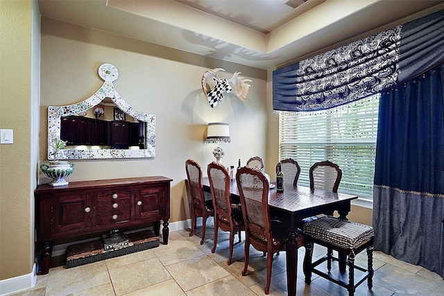 dining room with a raised ceiling