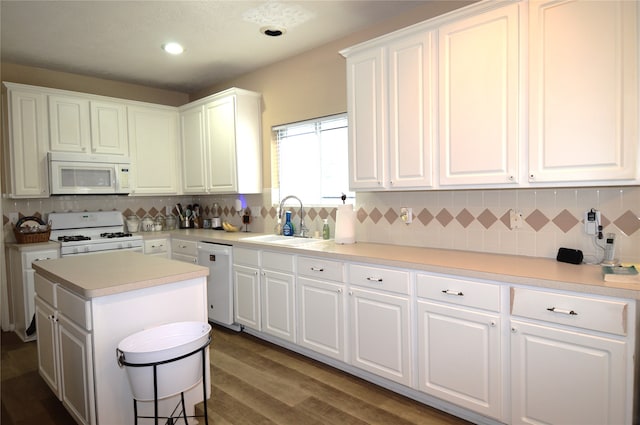 kitchen featuring white cabinetry, white appliances, sink, and dark wood-type flooring