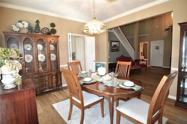 dining space with a notable chandelier, ornamental molding, and dark wood-type flooring