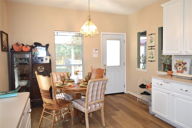 dining space featuring dark hardwood / wood-style flooring and a chandelier