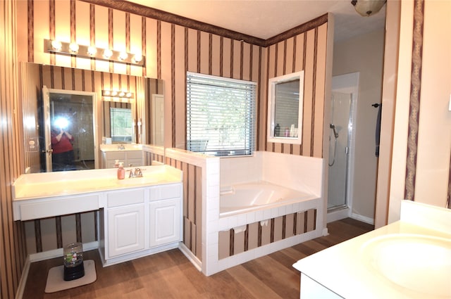 bathroom with hardwood / wood-style flooring, vanity, and independent shower and bath