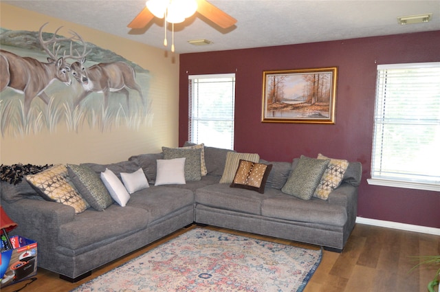 living room with hardwood / wood-style flooring, ceiling fan, and a healthy amount of sunlight