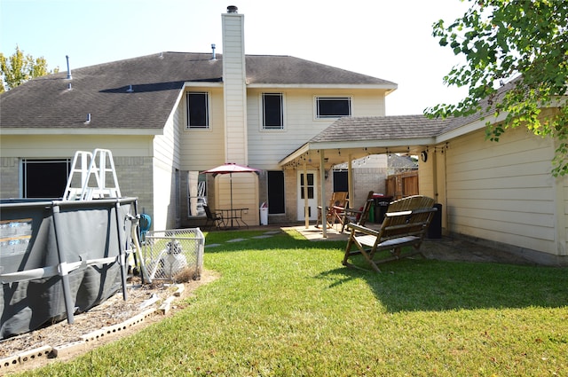 back of house with a lawn