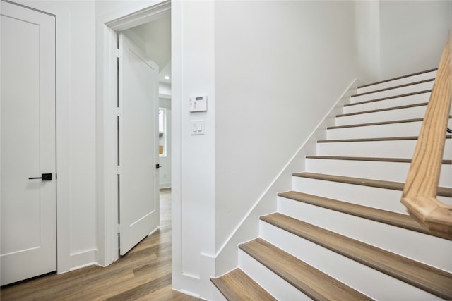 staircase with wood-type flooring