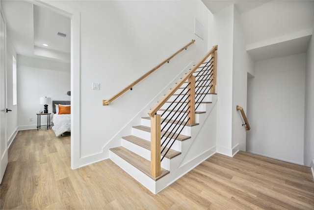 staircase featuring wood-type flooring