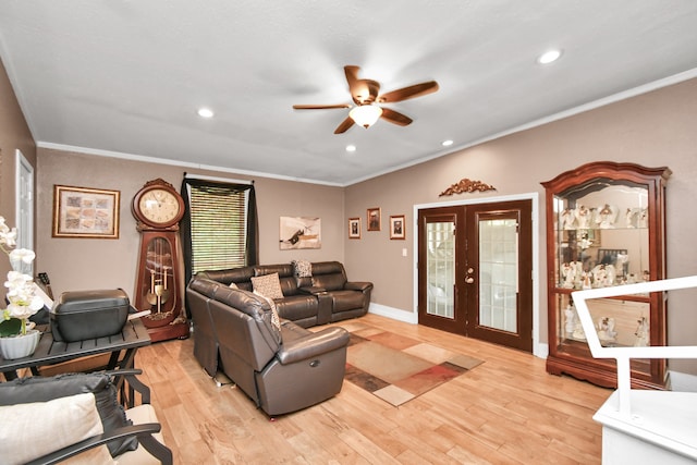 living room featuring ornamental molding, light hardwood / wood-style flooring, french doors, and ceiling fan