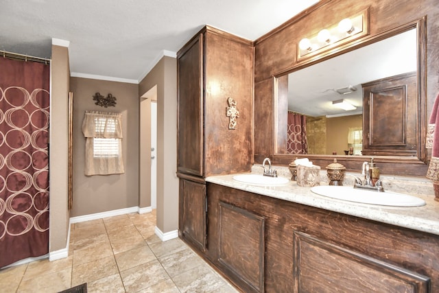 bathroom with vanity, tile patterned floors, ornamental molding, and a textured ceiling