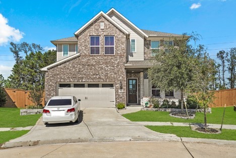 view of front of house with a garage and a front lawn