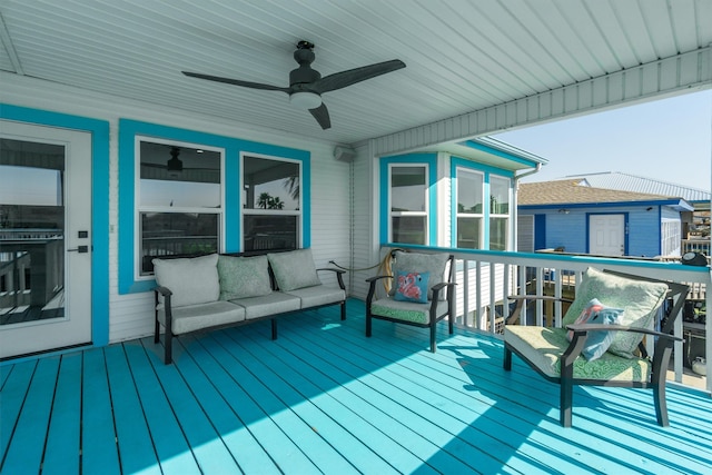 wooden deck featuring ceiling fan