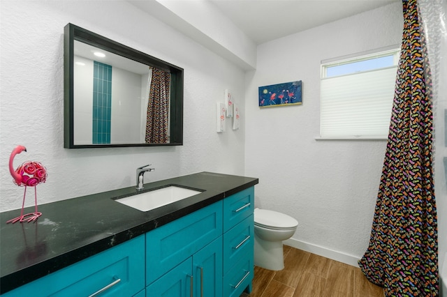 bathroom featuring hardwood / wood-style floors, toilet, and vanity