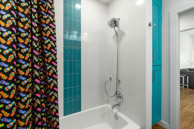 bathroom with hardwood / wood-style floors and shower / bath combo