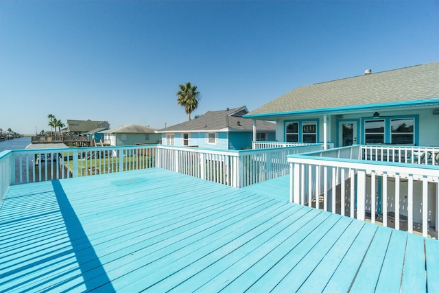 wooden terrace featuring a water view