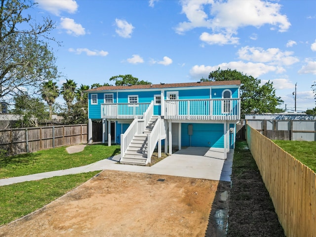 back of property with a yard and a carport