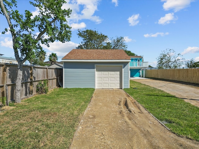 garage featuring a lawn