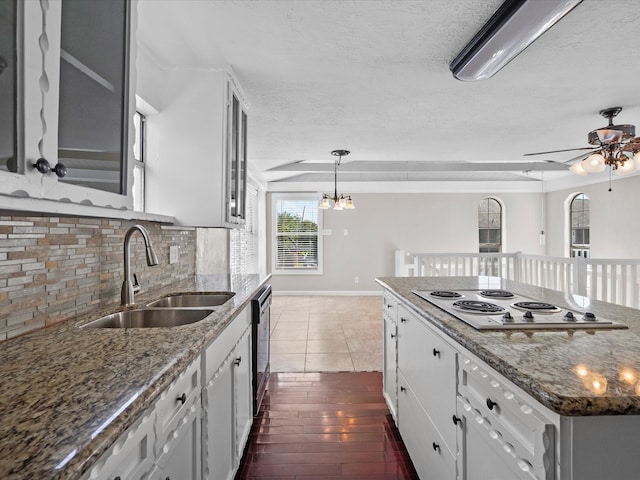 kitchen featuring white electric cooktop, sink, dark hardwood / wood-style flooring, white cabinetry, and dishwasher