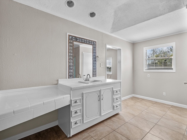 bathroom featuring tile patterned floors, vanity, and a textured ceiling