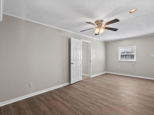 unfurnished room with hardwood / wood-style flooring, crown molding, and ceiling fan