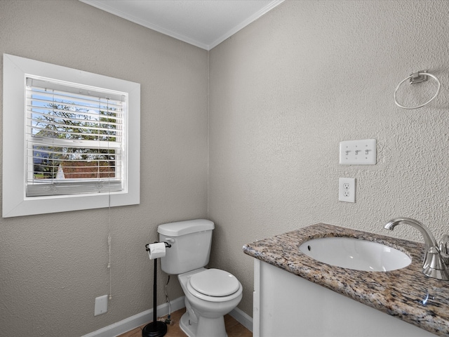 bathroom featuring vanity, crown molding, and toilet