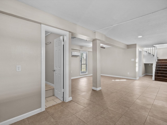 interior space featuring a wall unit AC and light tile patterned floors