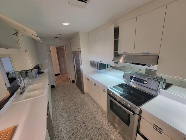 kitchen featuring range hood, white cabinetry, sink, and stainless steel appliances