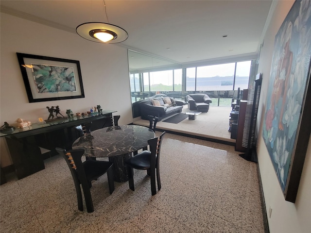 dining space featuring crown molding and a wealth of natural light